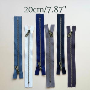 May include: Seven different colored zippers with antique brass pulls. The zippers are 20cm/7.87 inches long.