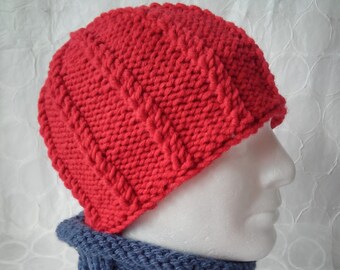 May include: A red knitted hat with a cable knit pattern and a matching blue knitted neck warmer.