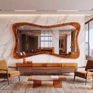 May include: A modern living room featuring a large, amber-colored, wavy-edged mirror. Two brown armchairs and a coffee table complement the decor. A wooden cabinet and marble wall add to the room's luxurious feel.