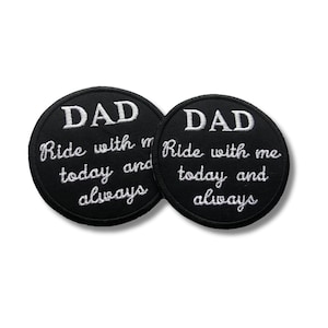 May include: Two circular black embroidered patches featuring white stitched text that reads DAD Ride with me today and always. The patches have a clean, round shape with a solid black background and contrasting white thread for the lettering.