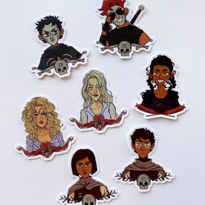 May include: A collection of seven character stickers. Each sticker features a stylized illustration of a person with unique hairstyles and clothing. Each character is paired with a skull and crossbones design, with Roman numerals. The stickers are on a white background.