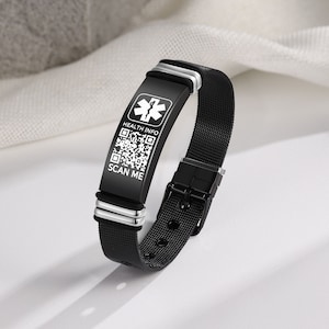 May include: Black medical ID bracelet with a mesh band and a rectangular plate. The plate features a medical symbol, the words "HEALTH INFO" and "SCAN ME", and a QR code. The bracelet has silver accents and a black buckle.