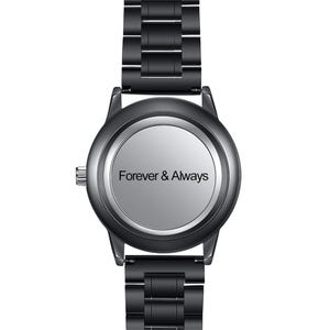 May include: A black metal wristwatch with a round case and a matching link bracelet. The watch face is a solid, smooth light gray circle featuring the black text Forever & Always centered in the middle. A small silver crown is on the left side.