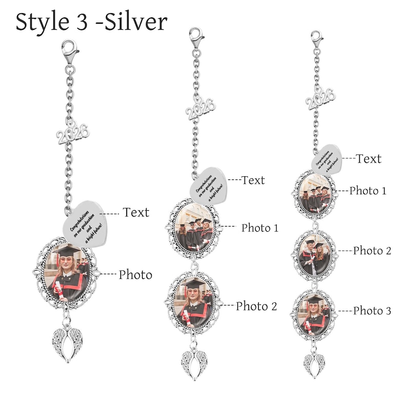 May include: Silver graduation car charm with a photo frame, angel wings, and the year 2026. The charm includes a heart-shaped tag with text. The photo frame is oval-shaped with an ornate border. The charm is designed to hold photos.