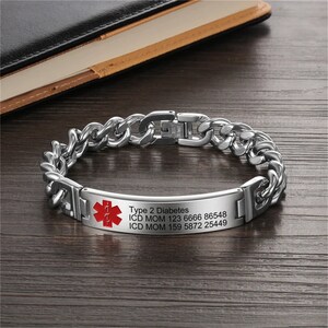 May include: A silver chain bracelet with a medical alert tag. The tag has a red star of life symbol and the text "Type 2 Diabetes, ICD MOM 123 6666 86548, ICD MOM 159 5872 25449".