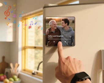May include: A square magnet with a photo of a father and son, with the text "Father and Daughter" and "Paul Simon". The magnet is on a refrigerator. Colorful musical notes are floating in the air.