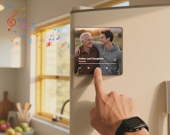 May include: A square magnet with a photo of two people, with the text "Father and Daughter" and a music player interface. A finger presses the play button. Colorful musical notes float above the magnet. The magnet is on a refrigerator.