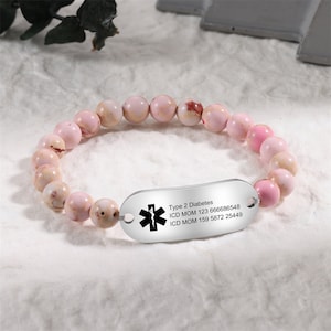 May include: Pink beaded bracelet with a silver medical alert tag that reads "Type 2 Diabetes, ICD MOM 123 666686548, ICD MOM 159 5872 25449".