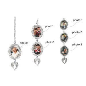 May include: Silver-toned photo pendants with oval frames and decorative filigree edges. Each pendant holds a photograph and is adorned with a small pair of angel wings. One pendant hangs from a chain, while the others are linked together.