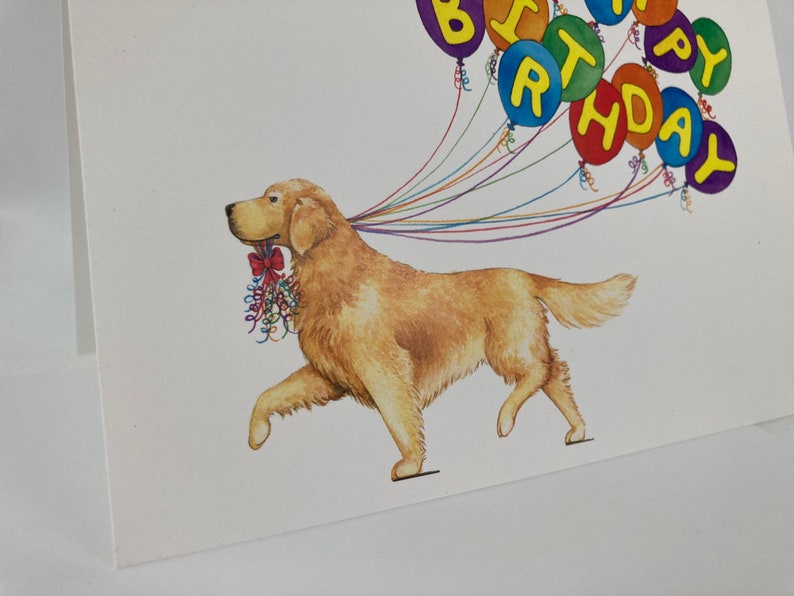 May include: A golden retriever dog runs with a string of colorful balloons that spell out "Happy Birthday".
