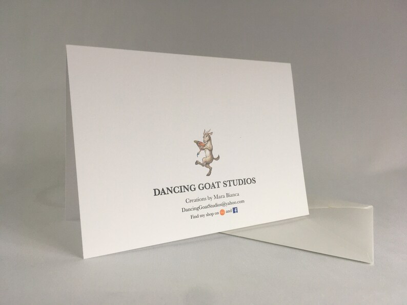 May include: White card with a logo of a goat dancing with a book. The text reads "Dancing Goat Studios" with the tagline "Creations by Mara Bianca" and the website "DancingGoatStudios@yahoo.com". The text "Find my shop on" is followed by icons for Etsy and Facebook.