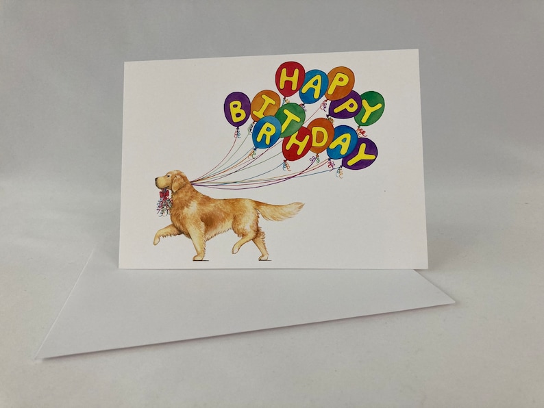 May include: A birthday card featuring a golden retriever dog carrying a string of colorful balloons that spell out "Happy Birthday".
