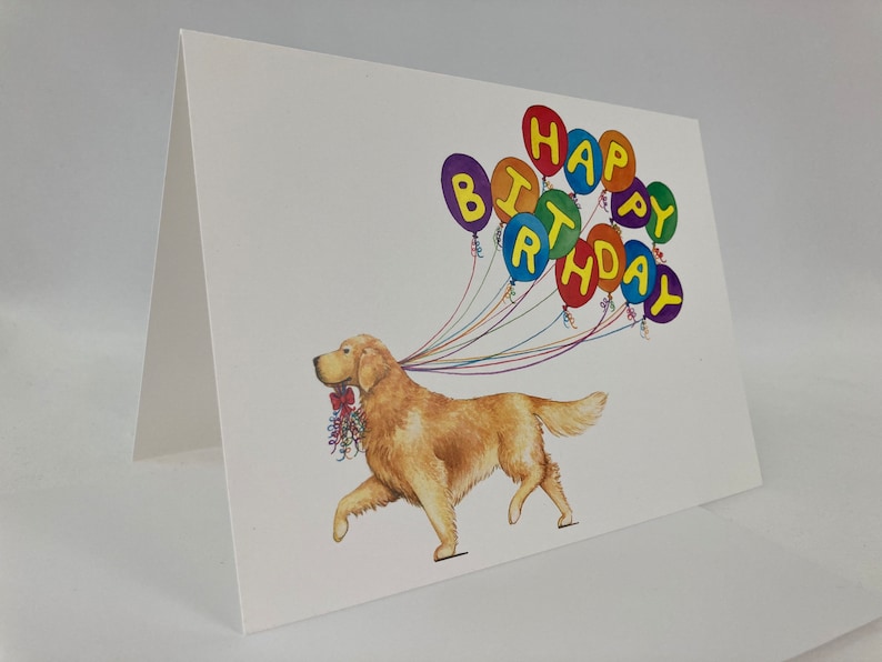 May include: A greeting card featuring a golden retriever dog with a string of colorful balloons that spell out "Happy Birthday".