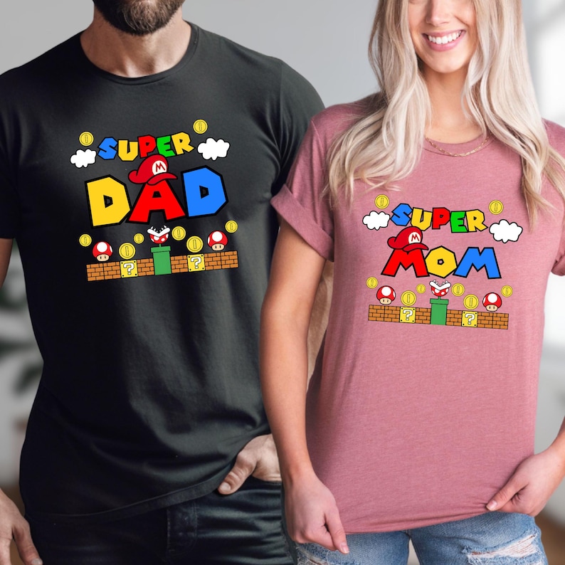 A man and a woman are standing next to each other, both wearing t-shirts with the same design.