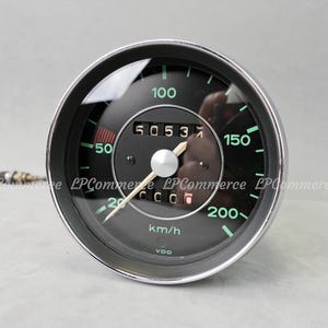 May include: A black and chrome speedometer with green markings and a white needle. The speedometer reads 50537 and has a maximum speed of 200 km/h. The gauge is round and has a reflective glass cover.