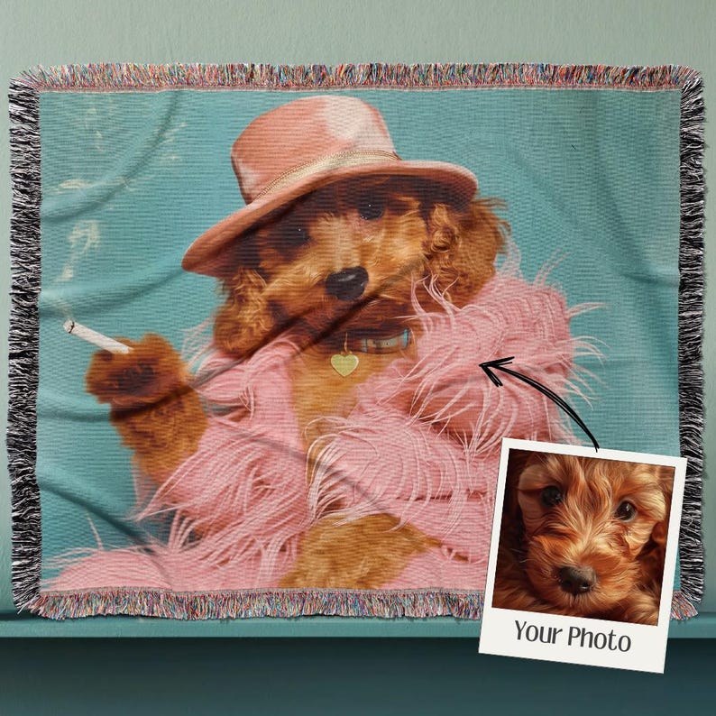 May include: A woven throw blanket with a vintage-style image of a dog wearing a pink feather boa and a hat. The dog is holding a cigarette in its paw. The image is surrounded by a colorful fringe border. The text "Your Photo" is printed on a white rectangle in the bottom right corner of the image.