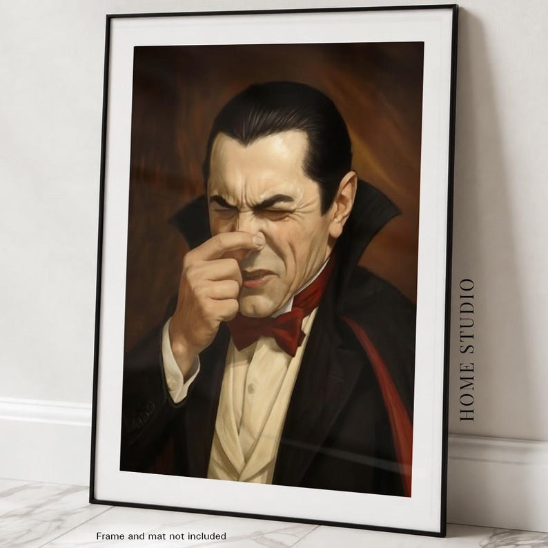 May include: A framed art print featuring a portrait of a pale individual with slicked-back dark hair, wearing a black suit, a cream-colored vest, and a red bow tie. The figure has a high-collared cape and is pinching their nose with one hand.