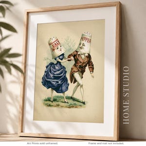 May include: A framed vintage print featuring anthropomorphic salt and pepper shakers dancing. The salt shaker wears a blue dress, and the pepper shaker wears a brown suit. The print has the words "SALT" and "PEPPER" on the shakers.