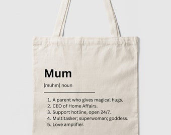 May include: A white tote bag with a black design that says "Mum [muhm] noun" and lists five qualities of a mother. The qualities include "A parent who gives magical hugs", "CEO of Home Affairs", "Support hotline, open 24/7", "Multitasker; superwoman; goddess", and "Love amplifier."