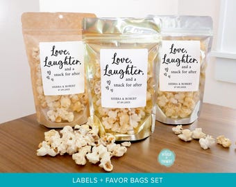 May include: Three stand-up pouches filled with popcorn, each featuring a white rectangular label with the text Love, Laughter, and a snack for after, Sierra & Robert, and 07.09.20XX. The bags have clear windows and are in kraft, gold, and silver.