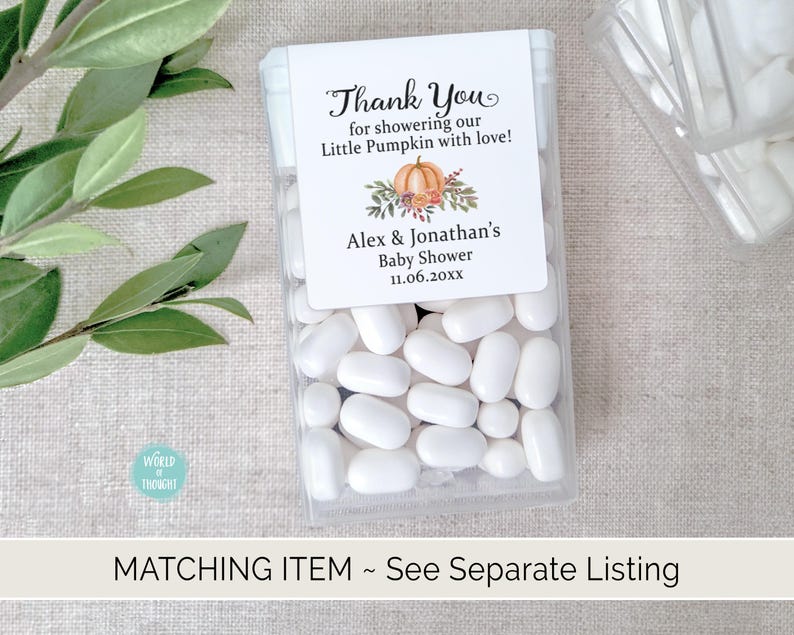 May include: A white favor box filled with white mints. The box has a label with the text "Thank You for showering our Little Pumpkin with love! Alex & Jonathan's Baby Shower 11.06.20xx". The label has a watercolor illustration of a pumpkin with fall leaves.