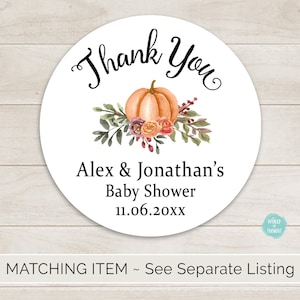 May include: Thank You sticker with a fall theme. The sticker features a pumpkin with floral accents and the text "Thank You", "Alex & Jonathan's", "Baby Shower", and "11.06.20xx".