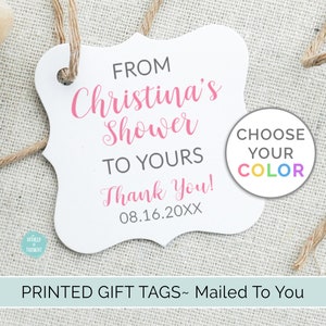May include: White gift tag with pink text that reads "From Christina's Shower To Yours Thank You! 08.16.20XX". A colorful circle with the text "Choose Your Color" is on the right side of the tag.