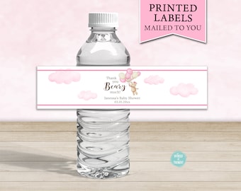 May include: Pink and white water bottle label with a cartoon bear holding balloons and the text "Thank you Beary much! Janessa's Baby Shower 03.01.20xx"