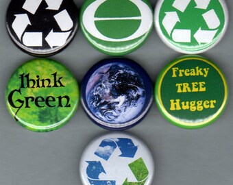 May include: Set of eight green and white round buttons with various environmental slogans and images. The buttons feature a green recycle symbol, a green circle with a white line, a green button with the text "Think Green", a green button with the text "Freaky Tree Hugger", a blue button with an image of the Earth, and a white button with a green recycle symbol with clouds and grass.