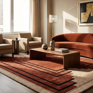 May include: A modern living room with a rust-colored rug featuring a geometric design. The room includes a rust-colored sofa, two beige armchairs, a wooden coffee table, and decorative vases. A gold chandelier and a floor lamp provide lighting.