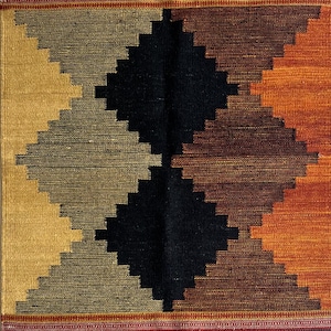 May include: A woven rug with a geometric pattern in shades of brown, black, orange, and red. The rug has a fringe border.