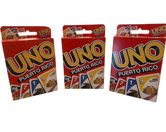 May include: Three identical red cardboard boxes of the card game UNO Puerto Rico. Each box features the large yellow and blue UNO logo, the text Puerto Rico, and illustrations of playing cards showing numbers and cultural imagery on the front.