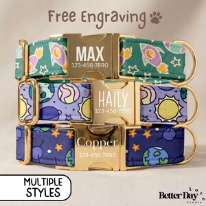 May include: Three pet collars with gold-tone metal buckles engraved with names and phone numbers. The top collar is teal with rockets and stars, the middle is light purple with planets and suns, and the bottom is dark blue with planets and stars.