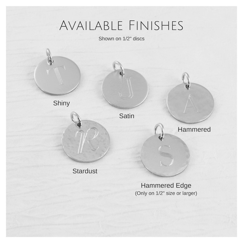 May include: Five silver discs with different finishes: shiny, satin, hammered, stardust, and hammered edge. The discs are 1.27 cm in diameter and show the letter "T", "J", "A", "R", and "S" engraved on them. The hammered edge finish is only available on discs 1.27 cm or larger.