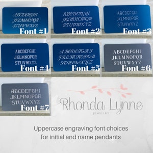 May include: A sample of seven different uppercase fonts for engraving on jewelry. The fonts are shown in white on a variety of colored backgrounds. The text includes the alphabet and the words "Font #1" through "Font #7". Below the fonts, the words "Rhonda Lynne Jewelry" are shown in a cursive font. The text "Uppercase engraving font choices for initial and name pendants" is shown below the logo.