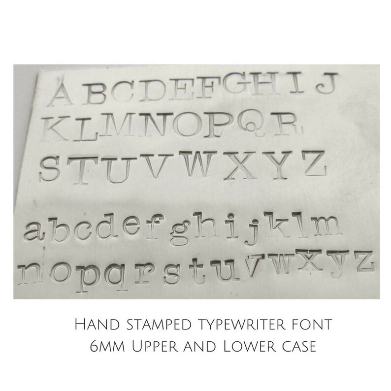 May include: A metal plate with the alphabet in uppercase and lowercase letters, stamped in a typewriter font. The text below reads "HAND STAMPED TYPEWRITER FONT 6MM UPPER AND LOWER CASE".