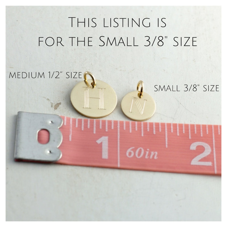 May include: Two gold-colored metal discs with engraved letters, "H" and "N", are shown next to a pink measuring tape. The tape reads "1/60in" and shows the discs are 3/8 inch in size. The text "THIS LISTING IS FOR THE SMALL 3/8" SIZE" and "MEDIUM 1/2" SIZE" is also visible.