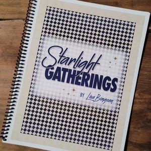 May include: A spiral-bound notebook with a cover featuring the text "Starlight Gatherings" in a stylized font. The cover has a checkered pattern in navy blue and white, with a cream-colored border. The author's name, Lisa Bongean, is also visible.