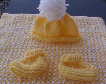 Large, hand knitted baby blanket in yellow and white with hat and booties