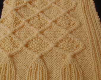 Yellow hand knitted  baby blanket with cables
