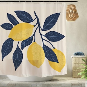 May include: A shower curtain featuring a cream-colored background with a large, central graphic of three yellow lemons hanging from a branch with dark navy blue leaves. The design is centered on the fabric, which hangs from a black curtain rod.