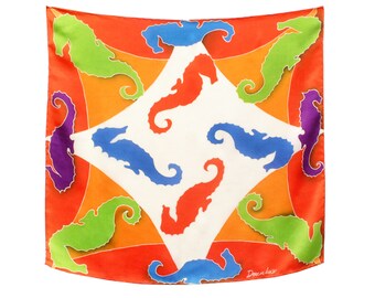 May include: A white silk scarf with a colorful pattern of seahorses. The seahorses are in shades of green, blue, purple, and orange. The scarf has a red border and the text "Donna Luce" in the bottom right corner.