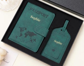 May include: A dark green passport holder and matching luggage tag set presented in a black gift box. The passport holder features the word PASSPORT, the name Sophie in gold, and a world map graphic. The luggage tag also displays the name Sophie.