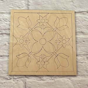 May include: A wooden square tile with a floral design. The design features four tulips and four flowers with five petals each.