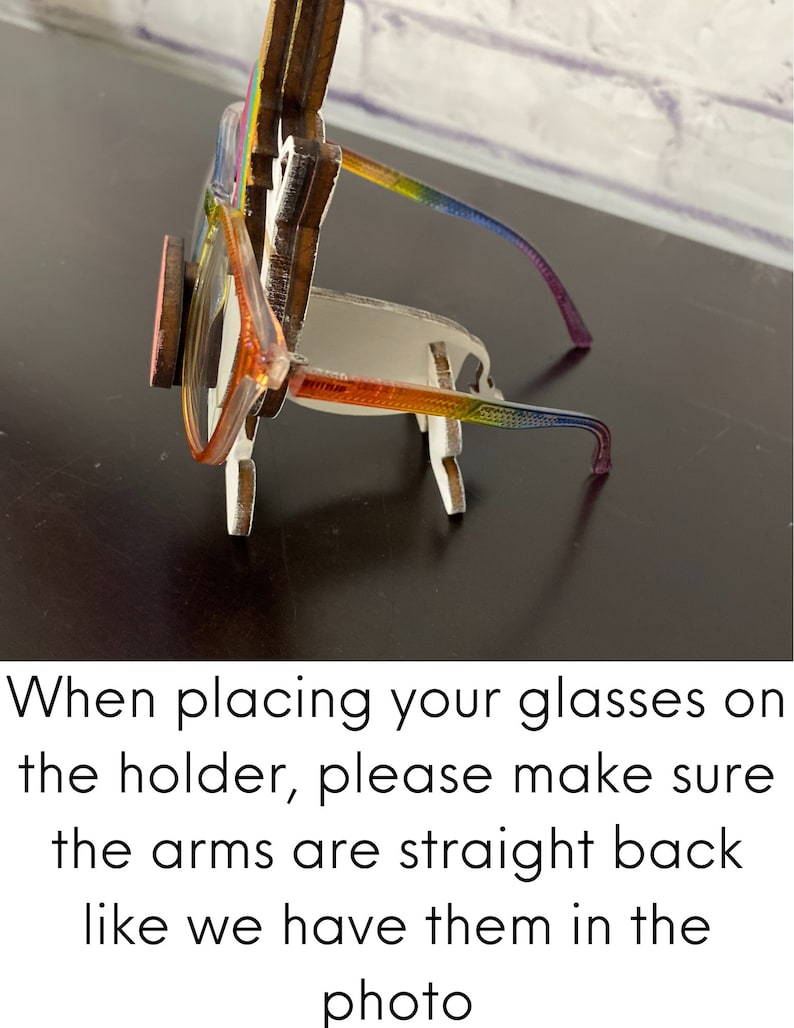 May include: A wooden glasses holder shaped like a unicorn with a rainbow mane and horn. The holder is designed to hold glasses with the arms straight back, as shown in the photo. When placing your glasses on the holder, please make sure the arms are straight back like we have them in the photo.