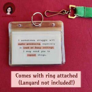 An example card, showing that the lanyard cards can be connected to a sunflower lanyard, with a keyring. Text reads, “Comes with ring attached - lanyard not included!” The example card reads, “I sometimes struggle with audio processing, especially in loud or busy settings. I may need you to repeat things.”