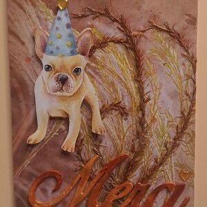 May include: A greeting card featuring a watercolor illustration of a French Bulldog wearing a party hat. The background has a brown and tan color scheme with decorative elements. The word "Merci" is written in orange script.