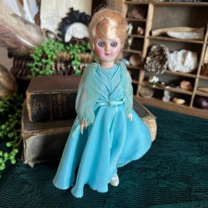 Vintage sleepy eye baby doll with blue dress / great for curiosity or oddities collection