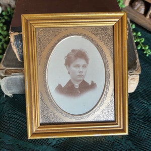 Antique photo of beautiful woman in gold frame