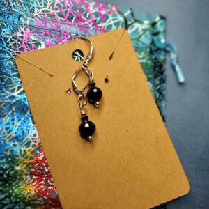 Crystal ball dangle earrings sterling silver plated made with Swarovski black and gold. Sku105